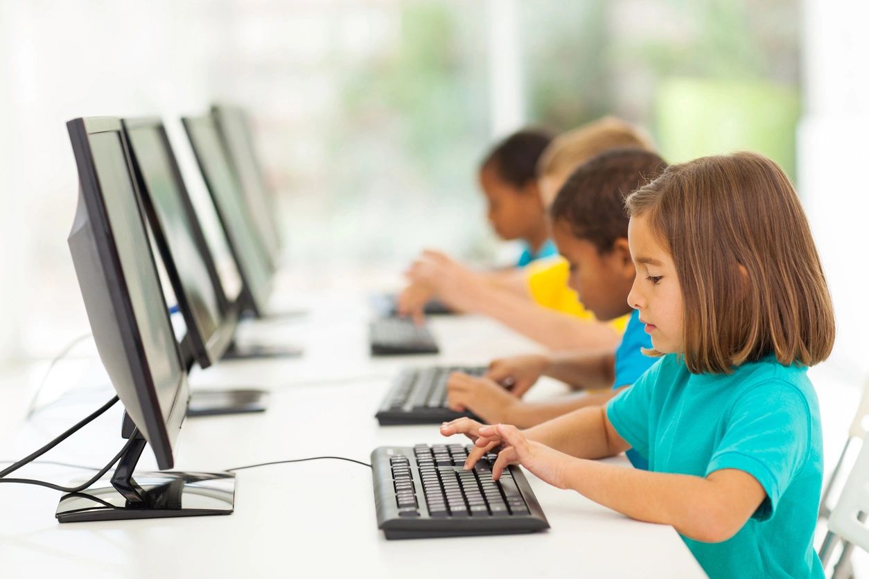 Children typing on a keyboard